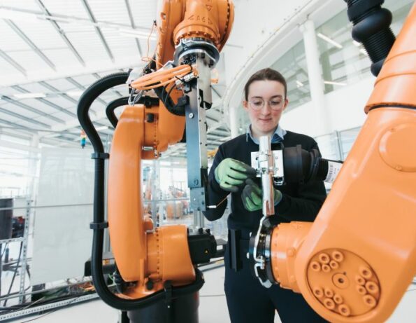 A Woman using machinery.