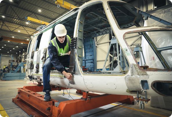 A Man working on a helicopter.